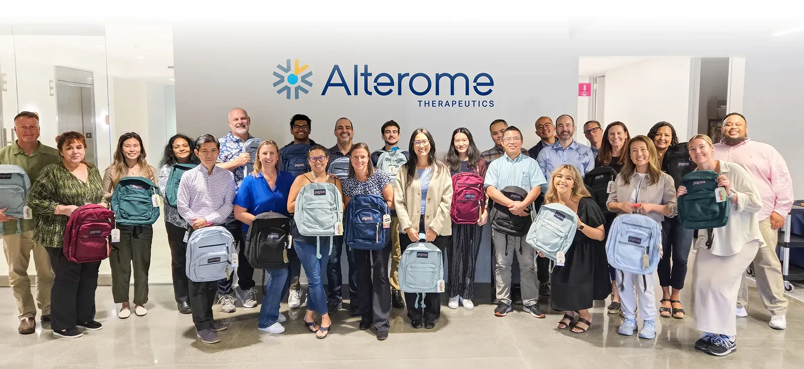 Alterome employees with Life Science Cares backpacks (volunteer opportunity)